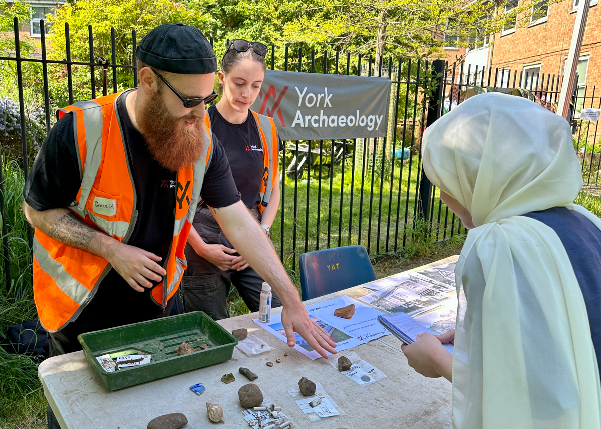 York Archaeology's community engagement team showing some finds to an open day visitor